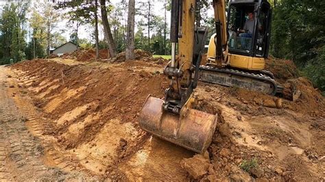 mini excavator ditching roads|digging a ditch with a mini.